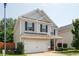 Charming two-story home with gray siding, black shutters, and well-maintained landscaping at 319 Nobleman Way, Canton, GA 30114