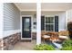 Charming front porch with a seating area, creating a welcoming entrance at 319 Nobleman Way, Canton, GA 30114