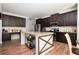 Spacious kitchen features stainless steel appliances, granite countertops, dark wood cabinets, and a kitchen island at 319 Nobleman Way, Canton, GA 30114