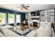 Cozy living room with built-in bookshelves, a fireplace, recessed lighting, and large windows at 319 Nobleman Way, Canton, GA 30114