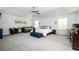 Spacious main bedroom with tray ceilings, a sitting area, ample natural light, and carpeted floors at 319 Nobleman Way, Canton, GA 30114