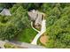Aerial perspective of the property revealing a long driveway and wooded surroundings at 3445 Strawberry Ln, Cumming, GA 30041