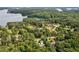 Stunning aerial view showcasing the lush landscape surrounding a lakeside home, ensuring a private and serene setting at 3445 Strawberry Ln, Cumming, GA 30041