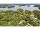 Breathtaking aerial view of a lakefront property surrounded by mature trees, offering privacy and scenic beauty at 3445 Strawberry Ln, Cumming, GA 30041