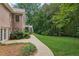Well-maintained backyard with manicured lawn, patio access, and a lush, green backdrop of trees at 3445 Strawberry Ln, Cumming, GA 30041
