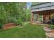 Expansive backyard with a view of the lower patio, a lush lawn, and mature trees at 3445 Strawberry Ln, Cumming, GA 30041