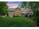Expansive backyard features lush lawn, mature trees, and an elevated deck perfect for outdoor enjoyment at 3445 Strawberry Ln, Cumming, GA 30041