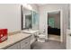 Stylish bathroom featuring a vanity with granite countertop, a toilet, and an open doorway at 3445 Strawberry Ln, Cumming, GA 30041