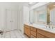 Bright bathroom features double sinks, wood cabinets, and tile floors at 3445 Strawberry Ln, Cumming, GA 30041