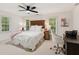 Bedroom with neutral-toned walls, carpet, a ceiling fan and large windows that let in natural light at 3445 Strawberry Ln, Cumming, GA 30041