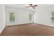 Spacious bedroom features a ceiling fan, neutral carpet and large windows for natural light at 3445 Strawberry Ln, Cumming, GA 30041