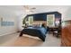 Comfortable bedroom featuring a dark blue accent wall, plush carpet, and lots of natural light at 3445 Strawberry Ln, Cumming, GA 30041