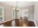 Dining room with chair railing, dark wood floors and modern light fixture at 3445 Strawberry Ln, Cumming, GA 30041