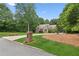 Attractive brick home featuring a circular driveway, mature trees, and manicured landscaping at 3445 Strawberry Ln, Cumming, GA 30041