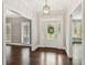 Elegant foyer with hardwood floors, decorative lighting, and views into adjacent living spaces at 3445 Strawberry Ln, Cumming, GA 30041