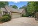 Spacious two-car garage with ample driveway space and outdoor seating area at 3445 Strawberry Ln, Cumming, GA 30041