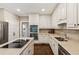 Bright kitchen features white cabinets, stainless appliances, granite countertops, kitchen island and hardwood floors at 3445 Strawberry Ln, Cumming, GA 30041