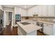 Kitchen features white cabinets, stainless appliances, granite countertops, kitchen island and hardwood floors at 3445 Strawberry Ln, Cumming, GA 30041