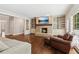 Bright living room with fireplace, built-ins, and large windows at 3445 Strawberry Ln, Cumming, GA 30041