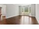 Bright living room featuring hardwood floors, ample natural light, and neutral wall color at 3445 Strawberry Ln, Cumming, GA 30041