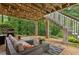 Relaxing outdoor patio area with comfortable seating, overhead lights, and a grill for entertaining at 3445 Strawberry Ln, Cumming, GA 30041