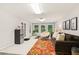 Bright recreation room with large windows, a comfortable couch, and stylish furnishings at 3445 Strawberry Ln, Cumming, GA 30041