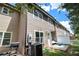 View of the rear of the townhome showing a patio, fence, and exterior siding at 7805 Rock Rose Ln, Fairburn, GA 30213