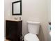 Cozy half-bathroom featuring a pedestal sink and framed mirror at 7805 Rock Rose Ln, Fairburn, GA 30213