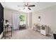 Spare bedroom with large window and ceiling fan at 7805 Rock Rose Ln, Fairburn, GA 30213
