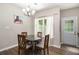 Cozy dining area with modern chandelier, adjacent to door and large windows at 7805 Rock Rose Ln, Fairburn, GA 30213