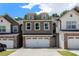 Beautiful townhome showcasing a two-car garage and attractive curb appeal in a desirable community at 7805 Rock Rose Ln, Fairburn, GA 30213