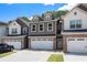 Charming townhome featuring a two-car garage and inviting curb appeal with neutral colors at 7805 Rock Rose Ln, Fairburn, GA 30213