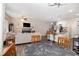 Open-concept living room adjacent to a dining area and kitchen, perfect for entertaining at 7805 Rock Rose Ln, Fairburn, GA 30213