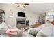Inviting living room showcasing a stone fireplace, modern decor, and comfortable seating at 7805 Rock Rose Ln, Fairburn, GA 30213