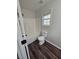 Bathroom featuring tub and shower combo, toilet, and dark wood flooring, creating a functional and stylish space at 1857 Oak Hill Springs Blvd, Lithonia, GA 30058