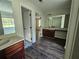 Bathroom with double vanity, new flooring, tub, and large mirror at 1857 Oak Hill Springs Blvd, Lithonia, GA 30058
