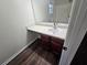 Bathroom vanity with a bright countertop, dark wood cabinets, and a clear mirror reflecting the space at 1857 Oak Hill Springs Blvd, Lithonia, GA 30058