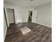Bedroom showcasing wood-look floors, neutral walls, and an open closet for ample storage at 1857 Oak Hill Springs Blvd, Lithonia, GA 30058