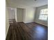 A well-lit bedroom with beautiful wood floors and a large window, offering a serene living space at 1857 Oak Hill Springs Blvd, Lithonia, GA 30058