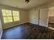Bright bedroom featuring wood-look flooring, light walls, and an exterior view from the window at 1857 Oak Hill Springs Blvd, Lithonia, GA 30058