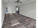 Large bedroom with new flooring, an open doorway, and a ceiling fan at 1857 Oak Hill Springs Blvd, Lithonia, GA 30058