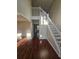 Bright foyer with hardwood floors, a staircase, and an open view into the living spaces at 1857 Oak Hill Springs Blvd, Lithonia, GA 30058