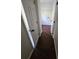 Hallway featuring wood floors leading to the laundry room with doors on either side at 1857 Oak Hill Springs Blvd, Lithonia, GA 30058