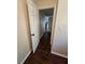 Hallway with hardwood floors showcasing white doors and neutral wall colors at 1857 Oak Hill Springs Blvd, Lithonia, GA 30058