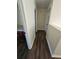 Narrow hallway with wood floors, clean white walls, and trim details, providing seamless transition between rooms at 1857 Oak Hill Springs Blvd, Lithonia, GA 30058