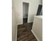 View of a hallway with neutral walls and baseboards, and wood-look flooring throughout at 1857 Oak Hill Springs Blvd, Lithonia, GA 30058
