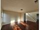 Spacious living room with hardwood floors, abundant sunlight, and staircase at 1857 Oak Hill Springs Blvd, Lithonia, GA 30058