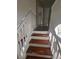 Staircase featuring hardwood steps, white risers, and white railings leading to the upper level at 1857 Oak Hill Springs Blvd, Lithonia, GA 30058