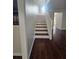 View of the staircase with contrasting dark wood floors and white risers and railing at 1857 Oak Hill Springs Blvd, Lithonia, GA 30058