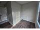 A walk-in closet with wood floors, a window, and a shelf, offering practical storage space at 1857 Oak Hill Springs Blvd, Lithonia, GA 30058